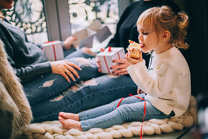 girl-eating-cupcake-while-sitting-beside-woman-in-blue-denim-1261408 副本.jpg